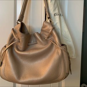 Medium/large Cole Haan purse with outside bag. Beige color with inside pockets.
